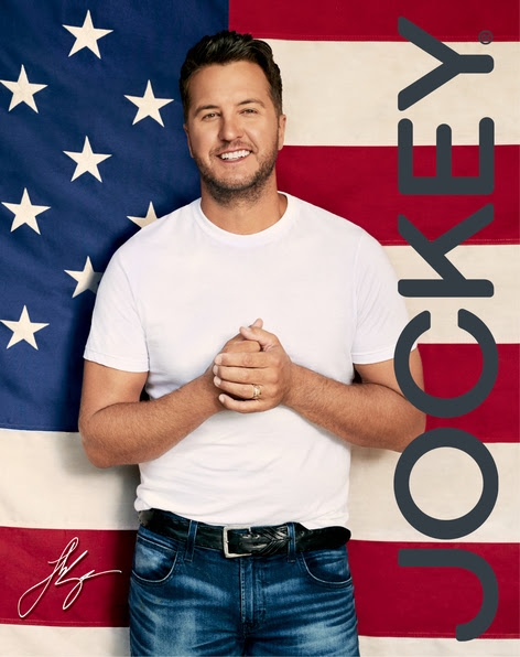 Luke Bryan with Jockey logo in front of American Flag